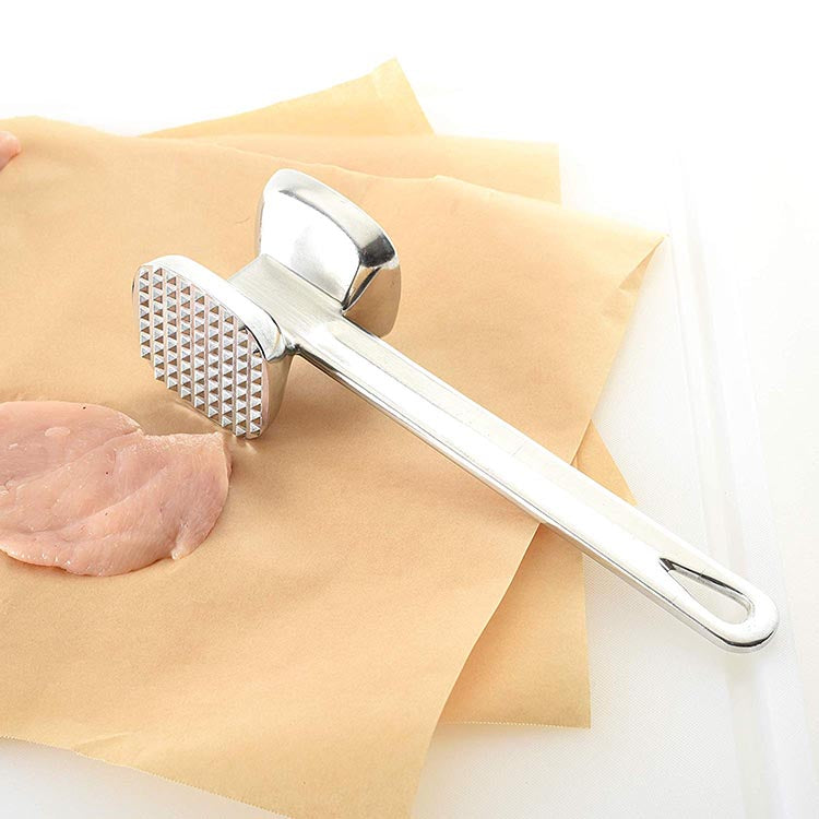 Two-sided meat hammer for tenderizing beef effectively. Two-sided meat hammer for tenderizing beef effectively.